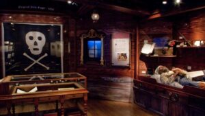 Interior of the pirate museum showing a jolly roger and pirate bunks